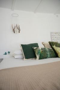 a living room with pillows on a couch at O Moinho da Roca in Azoia