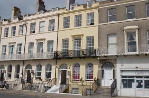 an apartment building on the corner of a street at The Edenhurst Guesthouse in Weymouth