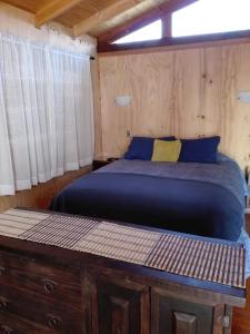 A bed or beds in a room at Cabaña Amor