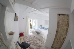 a white bedroom with a bed and a window at O Moinho da Roca in Azoia +21 photos