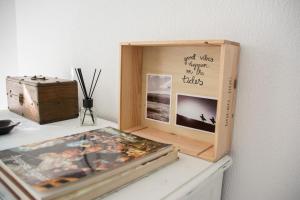 a picture frame sitting on a table next to a box at O Moinho da Roca in Azoia