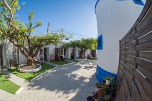 a house with a surfboard on the side of the road at O Moinho da Roca in Azoia