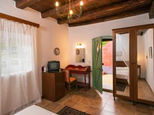 a room with a desk and a room with a bedroom at Villa De Loulia in Peroulades