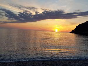 a sunset over the ocean with the sun setting at Imperial in Milazzo