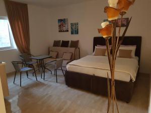 a bedroom with a bed and a table and chairs at Apartments Stuart in Utjeha