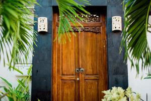 a wooden door on the side of a house at Villa Raka in Legian