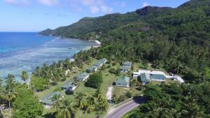 
a scenic view of a beach with palm trees at Chalets d'Anse Forbans SelfCatering in Takamaka
