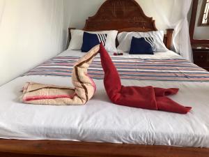 a bed with two towels sitting on top of it at Wilpattu Dolosmahe in Wilpattu +24 photos