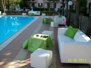 a pool with a white couch and a table next to it at Hotel Ambasciatori in Calitri