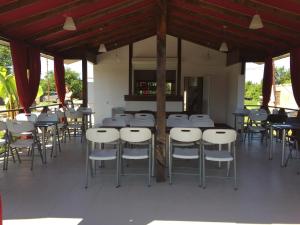 a group of tables and chairs on a patio at Dionisy Guest House in Pizunda