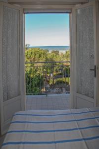 a bedroom with a bed and a view of the ocean at Hotel Annita Cervia in Cervia