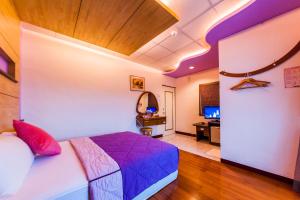 Postel nebo postele na pokoji v ubytování Kending Fengcai Homestay