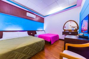 Voodi või voodid majutusasutuse Kending Fengcai Homestay toas