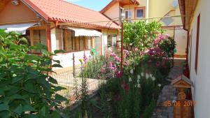 a garden in front of a house with flowers at Maria-Antonia in Mangalia
