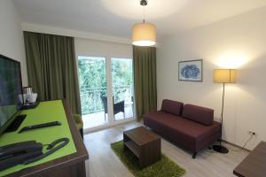 a living room with a couch and a table at Hotel Stanger in Lovran