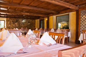 a dining room with white tables and chairs at Hotel Alador in Budoni