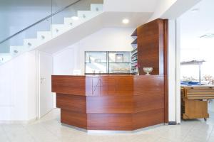 a staircase with a wooden wall in a house at Hotel ABC in Riccione