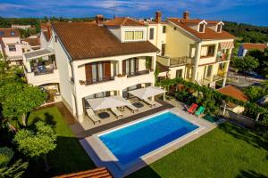 an aerial view of a house with a swimming pool at Premium Central Apartments in Vrsar