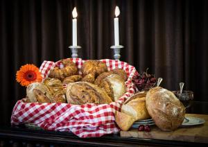 a basket of bread on a table with two candles at The Seasons Hotel -Studio & Suite in Netanya