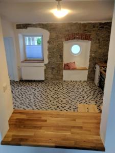 a room with a stone wall and a window at Wein und Stein in Randersacker