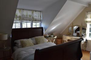 a bedroom with a bed and a staircase with a window at Almond Cottage Bed & Breakfast in Somerset West +70 photos