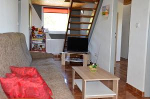 a living room with a couch and a staircase at Chaty Antónia in Hriňová