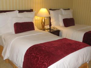 Postel nebo postele na pokoji v ubytování Clarion Hotel Tianjin