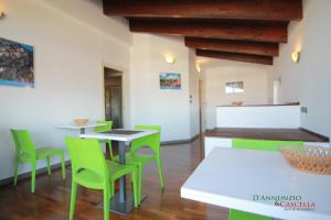 a dining room with green chairs and a table at B&B D'Annunzio in San Giovanni Teatino