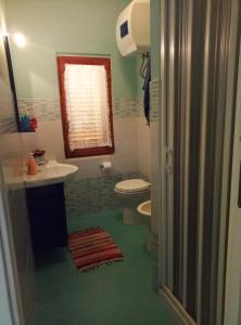 a bathroom with a toilet and a sink at Residence Covo degli Dei in Milazzo