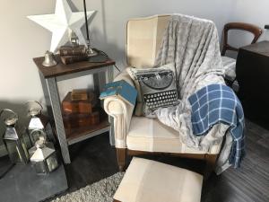 Un dormitorio con una silla con una manta. en Dippy cottage, en Bexhill-on-Sea