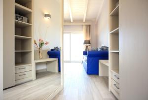 a walk in closet with a blue bed in a room at Bajaloglia Resort in Castelsardo