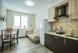 a kitchen and living room with a table and a refrigerator at Apartments on Leva st. in Berehove