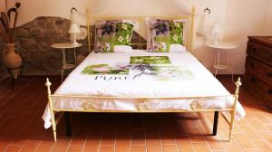 a bedroom with a bed with a white comforter at La Mariola Apartments in Santa Luce +112 photos