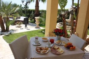 a table with plates of food on it at Villa Belvedere di Rita in Gallipoli