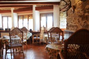 a restaurant with chairs and tables in a room at Hostal Refugio De Gredos in Navarredonda de Gredos