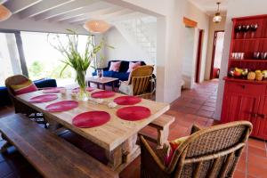a dining room with a wooden table and chairs at Seabreeze in Kommetjie