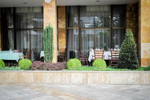 a restaurant with a table in front of a building at Hotel Sileks in Ohrid