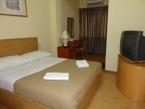 Postel nebo postele na pokoji v ubytování Pristine Hotel