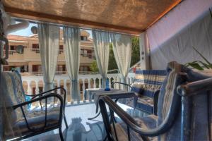 d'un balcon avec des chaises, une table et une fenêtre. dans l'établissement Apartment Mira, à Budva