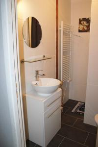 a bathroom with a sink and a mirror at Appartement Boucou in Buanes