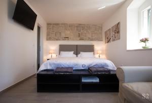 a bedroom with a large bed with two lamps at Morus Alba in Split