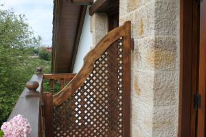 a wooden fence on the porch of a house at Posada La Estela Cántabra in Toñanes