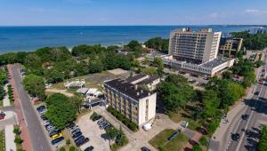 an aerial view of a city with a building and the ocean at Sopocki Zdrój Apartments in Sopot