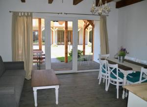 a living room with a couch and a table at Lawendowe domki in Karwia