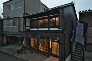 uma vista exterior de uma casa com uma escada em Kanazawa Guest House East Mountain em Kanazawa
