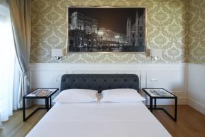 Postel nebo postele na pokoji v ubytování Suite Milano Duomo