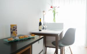 a table with a plate of food and a bottle of wine at Prima Tel Aviv Hotel in Tel Aviv