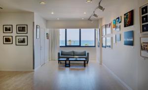 a living room with a couch and a table at Prima Tel Aviv Hotel in Tel Aviv