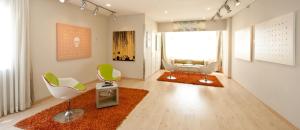 a living room with two chairs and a couch at Prima Tel Aviv Hotel in Tel Aviv