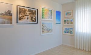 a group of pictures on a wall in a room at Prima Tel Aviv Hotel in Tel Aviv